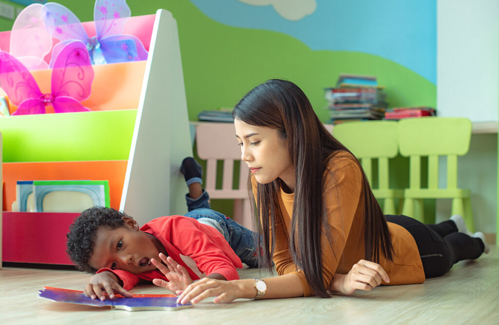 young woman teacher try to rise up a preschool as stubborn of boys to pay learning and attention in studying, naughty boys out ot controll in classroom at kindergarten pre school. Uncontrolled behaviour